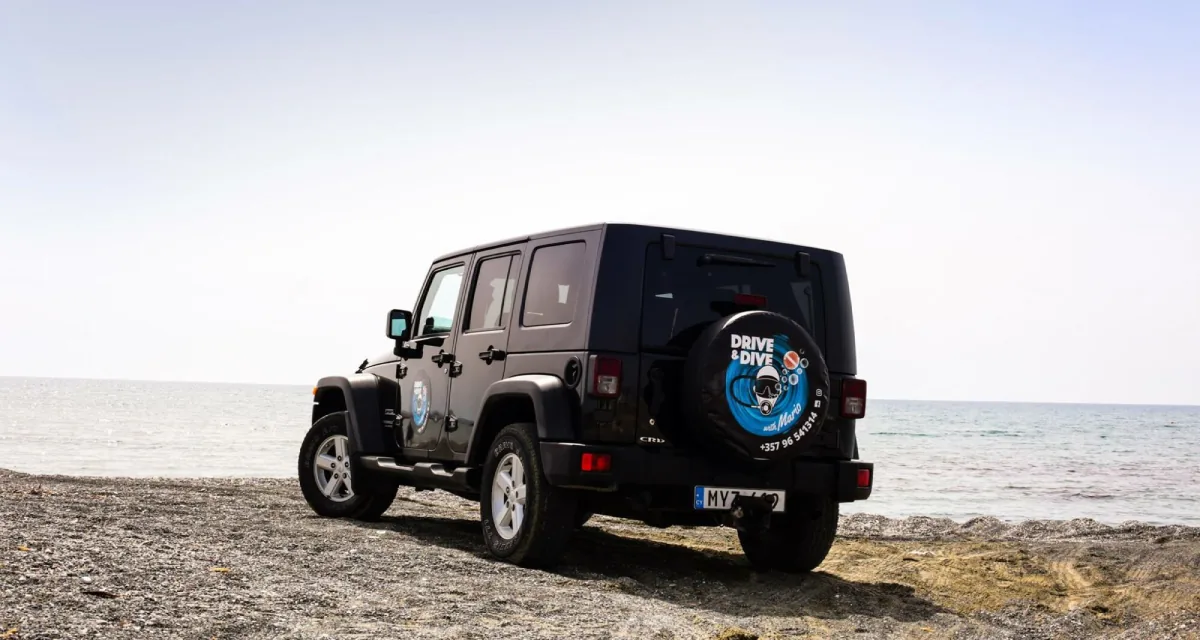 The Drive & Dive with Mario jeep parked on a Cyprus beach by the sea